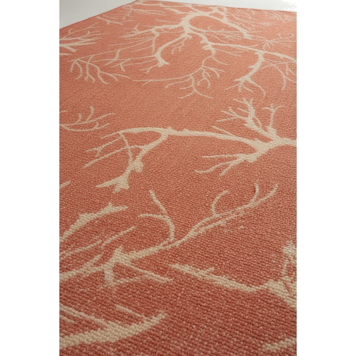 new-orange-color-texture-close-up-5 {image_id: crop_4, image_type: detail_photo, alt_text: Partial view of the rug, highlighting the white branch design on orange.}