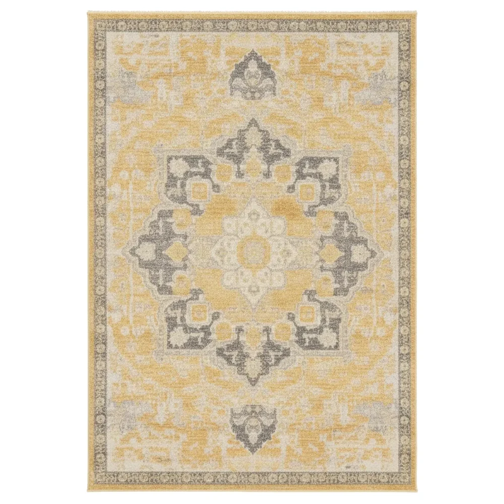Angled view of a rectangular modern contemporary rug with a distressed yellow and gray abstract pattern on a gray floor.