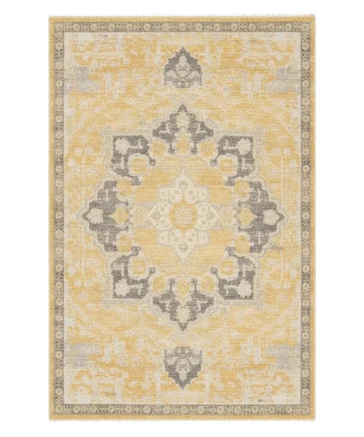 Close-up view of a modern rectangular area rug with a distressed yellow