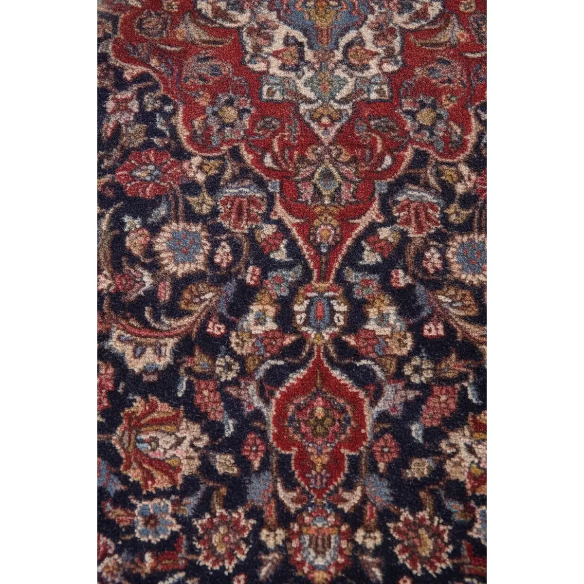 9x12-navy-red-medallion-area-rug-texture-close-up-5 Detail view of the right side of a rug